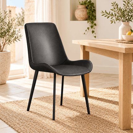 Dark grey leather-look dining chair beside a wooden dining table
