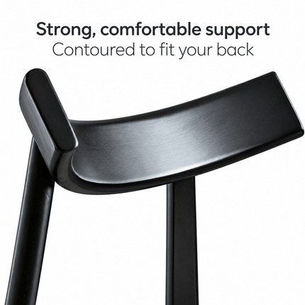 Close-up of the curved black wooden backrest on a modern dining chair
