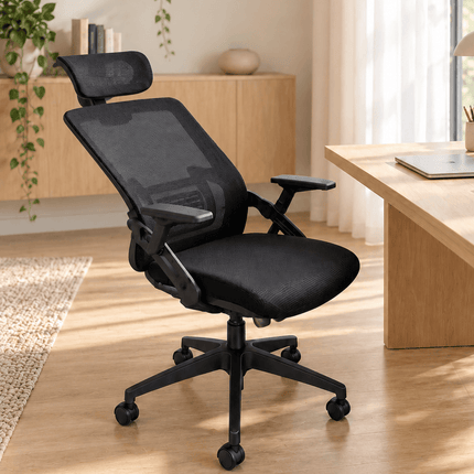 Black mesh office chair with reclining backrest in a relaxed tilted position