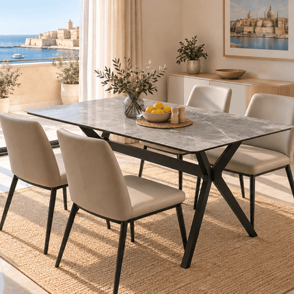 Grey sintered stone dining table with black X-shaped legs in a Mediterranean-style dining room