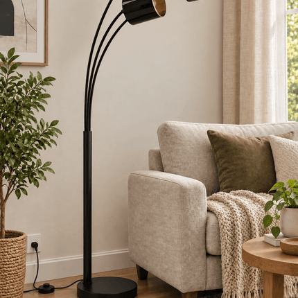 Black 3-light arc floor lamp with three curved arms in a modern living room