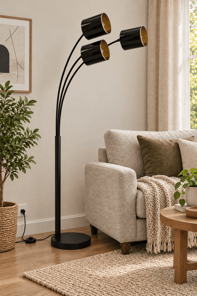 Black 3-light arc floor lamp with three curved arms in a modern living room