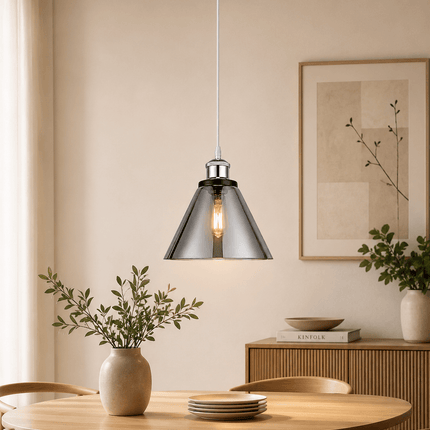 Modern chrome cone pendant light above dining table in contemporary interior