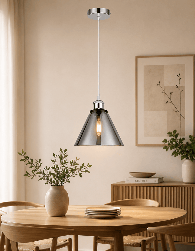 Modern chrome cone pendant light above dining table in contemporary interior