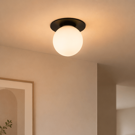 Modern black glass globe flush mount ceiling light in minimalist interior