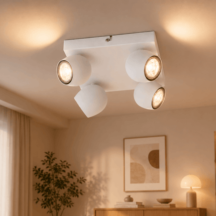 Modern 4-light matt white ceiling spotlight installed in contemporary living room interior