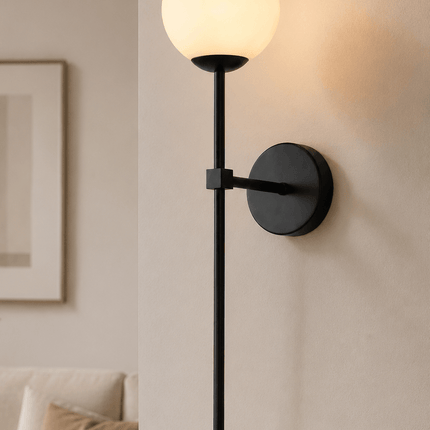 Modern black wall sconce with glass globe in contemporary living room