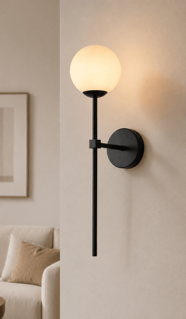 Modern black wall sconce with glass globe in contemporary living room