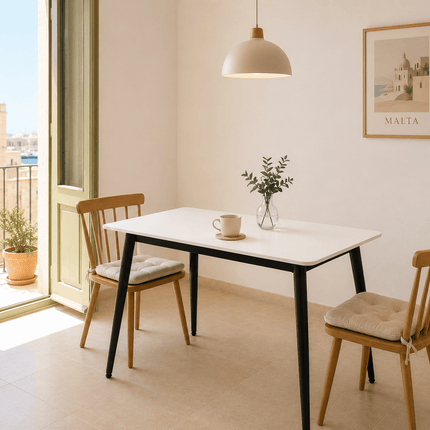 Modern white dining table with black legs in apartment dining room