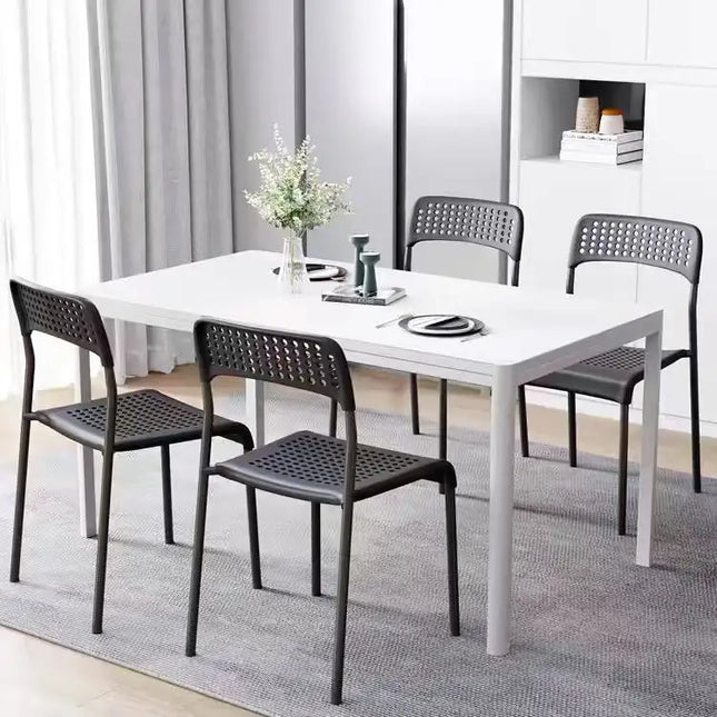 Plastic metal dining chairs around dining table in modern dining room