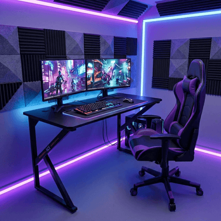Black gaming desk with dual monitor RGB gaming setup