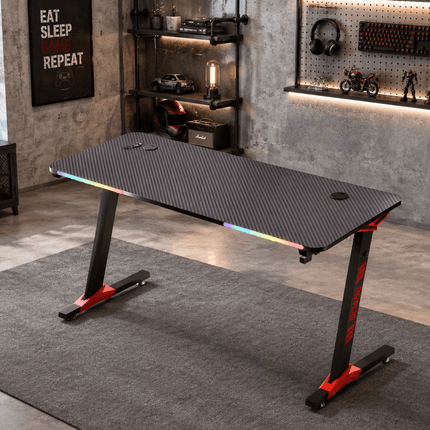 Modern RGB gaming desk setup in industrial style gaming room with LED lights